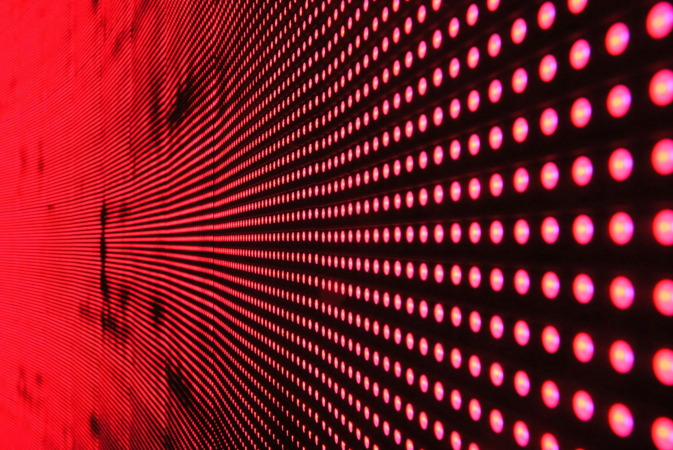 A close up grid of a red light LED display, highlighting the technology behind red and near-infrared light therapy devices